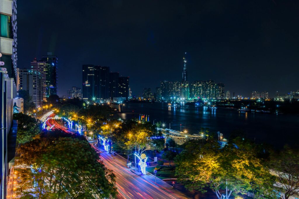 pexels-photo-980221-980221 Stunning nighttime view of Ho Chi Minh City's skyline with illuminated roads and skyscrapers by the Saigon River.